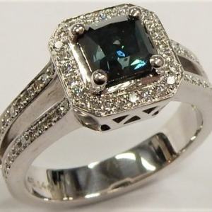 Estate Diamond Dinner Ring - Women's 
14 Karat White Estate Dinner Ring 
Finger Size 6.5 Gram Weight 6.4 
1 Center Diamond; 1.00ct Shape: Princess With 72 Round Diamonds 0.40 ctw 1.4