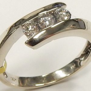 Estate Diamond Dinner Ring - Women's 
14 Karat White Estate Dinner Ring 
Finger Size 6.75 Gram Weight 3.1 
3 Center Diamonds Shape: Round; Clarity: SI1; Colour: I/J 0.33