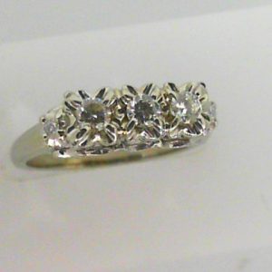 Estate Diamond Dinner Ring - Women's 
18 Karat White Estate Dinner Ring 
Finger Size 7 Gram Weight 4.31 
3 Center Diamonds Shape: Round; Clarity: VS; Colour: H 0.33