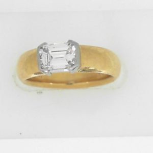 Estate Diamond Dinner Ring - Women's 
18 Karat Yellow Estate Dinner Ring 
Finger Size 6 Gram Weight 7.1 
1 Center Diamond; 0.75ct Shape: Emerald; Clarity: VS; Colour: G 0.75