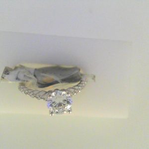 Diamond Semi-Mount Ring 
18 Karat White Ring 
Finger Size 6 
 Center Diamond Shape: Round; Clarity: VS1; Colour: F/G 0.21