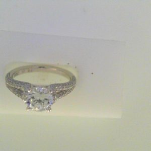 Diamond Semi-Mount Ring 
18 Karat White Ring 
Finger Size 7 
 Center Diamond Shape: Round; Clarity: VS1; Colour: F/G 0.44