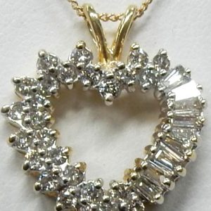 Estate Diamond Pendant/Necklace 
14 Karat Yellow Estate Diamond Pendant 
Gram Weight 4.3 Chain Style: Curb 14 Karat Yellow 18 
9 Center Diamonds Shape: Baguette; Clarity: SI-I1; Colour: J/K With 28 Round Diamonds 50.00 ctw 50.25