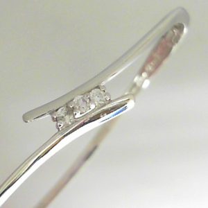 Estate Diamond Bracelet 
10 Karat White Estate Diamond Bracelet 
Gram Weight 9.1 
3 Center Diamonds Shape: Round; Clarity: I1; Colour: J 0.12