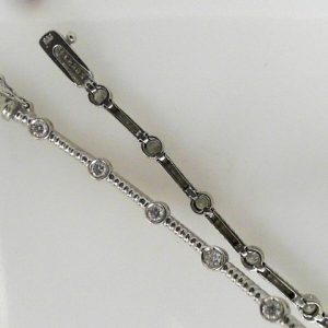 Estate Diamond Bracelet 
14 Karat White Estate Diamond Bracelet Length: 7.5in 
Gram Weight 9.98 
13 Center Diamonds Shape: Round; Clarity: SI2; Colour: G/H 1.2