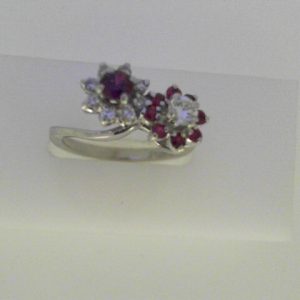 Rubies Ring 
14 Karat White Rubies Ring With Finger Size 6 
Width 2.14mm Gram Weight 3.92 
9 Center Rubies Shape: Round With 9 Round Diamonds