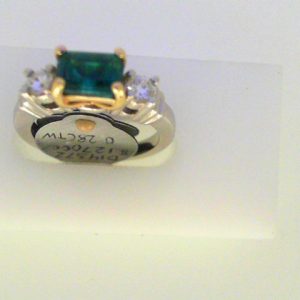 Quartz Ring 
14 Karat Yellow/White Green Blue Quartz Ring With Finger Size 6 
Width 2.31mm Gram Weight 5.31 
1 Center Quartz Shape: Emerald; Colour: Green Blue With 2 Round Diamonds 0.28 ctw