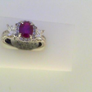 Rubies Ring 
18 Karat White Rubies Ring With Finger Size 6.75 
 Gram Weight 5.9 
11 Center Rubies Shape: Oval With 2 Princess Diamonds 0.80 ctw and 14 Round Diamonds 0.07 ctw