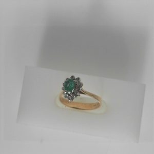 Emerald Ring 
14 Karat Yellow/White Emerald Ring With Finger Size 6 
 
1 Center Emerald Shape: Pear Round Diamond 0.20 ctw