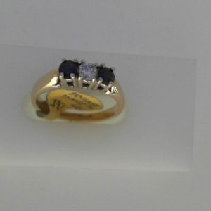 Sapphires Estate Ring 
14 Karat Yellow Sapphires Ring With Finger Size 6.5 
Width 2.35mm Gram Weight 3 
2 Center Sapphires Shape: Round With 1 Round Diamond 0.13 ctw