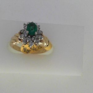 Emerald Estate Ring 
14 Karat Yellow/White Emerald Ring With Finger Size 4.75 
Width 2.22mm Gram Weight 3.79 
1 Center Emerald Shape: Oval With 20 Round Diamonds 0.33 ctw