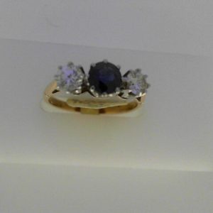 Sapphire Estate Ring 
18 Karat Yellow/White Sapphire Ring With Finger Size 6.5 
Width 1.95mm Gram Weight 3.05 
1 Center Sapphire Shape: Round With 2 Round Diamonds 0.58 ctw
