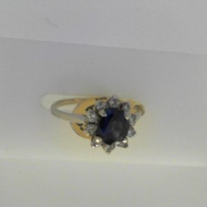 Sapphire Estate Ring 
14 Karat White Sapphire Ring With Finger Size 6 
Width 1.41mm Gram Weight 2.1 
1 Center Sapphire 0.83ct Shape: Oval With 10 Round Diamonds 0.15 ctw