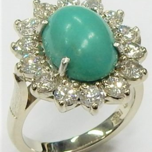 Turquoise Estate Ring 
18 Karat White Greenish Blue Turquoise Ring With Finger Size 5 
 Gram Weight 6.7 
1 Center Turquoise Shape: Oval; Colour: Greenish Blue Round Diamond 1.25 ctw