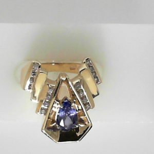 Tanzanite Estate Ring 
14 Karat Yellow Tanzanite Ring 
 Gram Weight 7.83 
1 Center Tanzanite 0.67ct Shape: Pear With 16 Round Diamonds 0.25 ctw