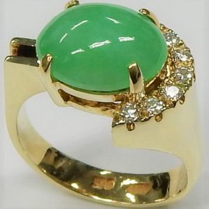 Jade Estate Ring 
14 Karat Yellow Jade Ring With Finger Size 5.25 
 Gram Weight 6.25 
1 Center Jade Shape: Oval With 7 Round Diamonds