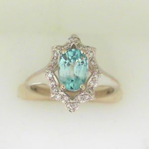 Blue Zircon Estate Ring
10 Karat White Blue Topaz Ring With Finger Size 5.5
Gram Weight 2.72
1 Center Topaz Shape: Oval; Colour: Blue With 24 Round Diamonds 0.20 ctw