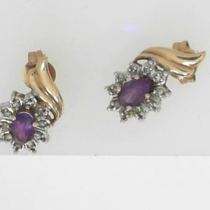 Estate Earrings With Amethysts 
10 Karat Yellow/White Amethysts Earrings 
 Gram Weight 1.9 
2 Center Amethysts Shape: Oval With 20 Round Diamonds
