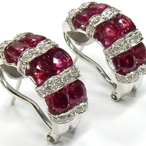 Estate Earrings 
18 Karat White glold ruby earrings 
 Length: 0.75in Gram Weight 12.3 
12 Rubies Shape: Oval; Clarity: SI1; Colour: Red 5.00 ct. tw. 36 Round Diamonds 0.40 ctw SI-HI