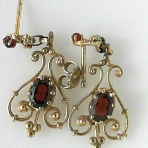 Estate Earrings With Garnets 
10 Karat Yellow Garnets Earrings 
 Gram Weight 4 
2 Center Garnets Shape: Oval