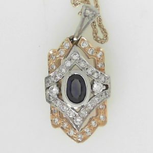 Sapphire Estate Pendant 
14 Karat Yellow/White Blue Sapphire Pendant 
Gram Weight 7.47 Chain Style: Rope 14 Karat Yellow Length: 18in 
1 Center Sapphire Shape: Oval; Colour: Blue With 39 Round Diamonds 0.74 ctw
