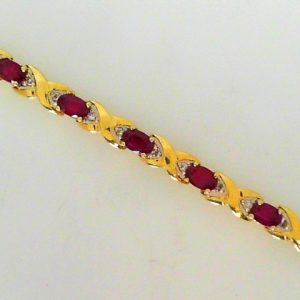 Estate Bracelet With Rubies
14 Karat Yellow Rubies Bracelet Length: 7.5in
Gram Weight 9.4
17 Center Rubies Shape: Oval With 34 Round Diamonds 0.40 ctw