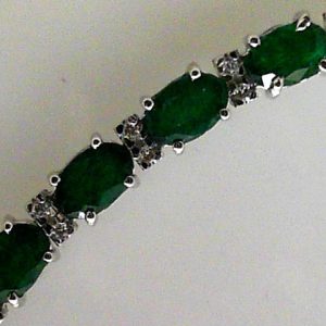 Estate Bracelet With Emeralds
14 Karat White Emeralds Bracelet Length: 7in Width: 4.7mm
Gram Weight 10.4
23 Center Emeralds Shape: Oval With 46 Round Diamonds 0.34 ctw