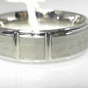 White 10 Karat Hammered Band Ring 
Size: 10 
Gram Weight 7.04 gr