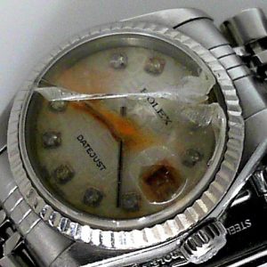 Estate Rolex Dress Year: 2004
Vendor Style #: 79174 Datejust 26 SN: F673092 Jubilee
26mm 18K/Stainless Steel
Dial: Silver Jubilee diamond 
Box Not Included/Papers Included
Condition Poor (Rusted solid, smashed crystal, ruined dial)
For parts only.