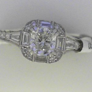 Diamond Engagement Ring 
18 Karat White Engagement Ring 0.86twt
Finger Size 6.5 
1 Center Diamond 0.56ct Shape: Cushion CAD DIA With 6 Emerald Diamonds 0.15 ctw and 22 Round Diamonds 0.15 ctw 0.86