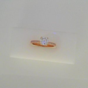 Diamond Engagement Ring 
14 Karat Rose/White Engagement Ring 0.79twt
Finger Size 6.5 
1 Center Diamond 0.69ct Shape: Round Clarity: SI2 Colour: I Round Diamond 0.10 ctw 0.79