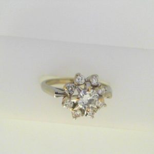 Estate Diamond Engagement Ring 
18 Karat White Estate Engagement Ring 
Finger Size 7 Gram Weight 4 
1 Center Diamond 0.40ct Shape: Round; Clarity: VS1; Colour: G With 8 Round Diamonds 0.30 ctw 0.7