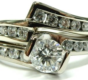 Estate Diamond Engagement Ring 
14 Karat White Estate Engagement Ring Width 1.9mm 
Finger Size 6 Gram Weight 5.7 
1 Center Diamond 0.40ct Shape: Round; Clarity: I1; Colour: H With 26 Round Diamonds 0.50 ctw 0.9