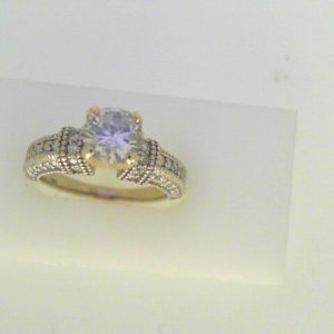 Estate Diamond Engagement Ring 
14 Karat White Estate Engagement Ring Width 2.2mm 
Finger Size 6.25 Gram Weight 5 
1 Center Diamond 1.01ct Shape: Round; Clarity: I2; Colour: I With 50 Round Diamonds 0.50 ctw 1.51