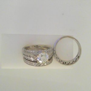 Estate Diamond Engagement Ring 
14 Karat White Estate Engagement Ring 
Finger Size 6 Gram Weight 11.2 
1 Center Diamond 1.25ct Shape: Round; Clarity: I1; Colour: D; GIA 5201329552 Various Shapes Diamond 0.80 ctw 2.05