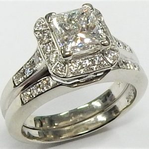 Estate Diamond Engagement Ring 
18 Karat White Estate Engagement Ring 
Finger Size 4.5 Gram Weight 7.2 
1 Center Diamond 0.98ct Shape: Princess; Clarity: VS1; Colour: H Round Diamond 0.38 ctw 1.36