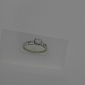 Estate Diamond Engagement Ring 
Platinum White Estate Engagement Ring 
Finger Size 6.25 Gram Weight 3.48 
1 Center Diamond 0.27ct Shape: Round; Clarity: SI; Colour: F/G With 6 Various Shapes Diamonds 0.17 ctw 0.44