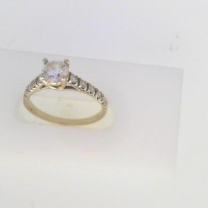 Estate Diamond Engagement Ring 
19 Karat White Estate Engagement Ring 
Finger Size 6 Gram Weight 2.1 
1 Center Diamond 0.44ct Shape: Round; Clarity: SI2; Colour: H With 10 Round Diamonds 0.25 ctw 0.69