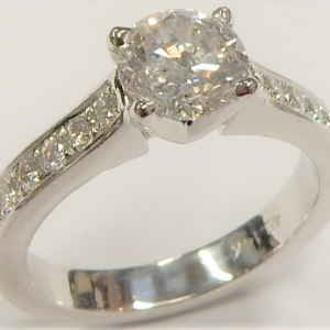 Estate Diamond Engagement Ring 
14 Karat White Estate Engagement Ring 
Finger Size 6 Gram Weight 5 
1 Center Diamond 1.00ct Shape: Round; Clarity: I1; Colour: H With 12 Round Diamonds 0.25 ctw 1.25