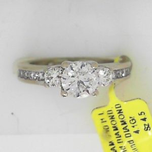 Estate Diamond Engagement Ring 
14 Karat White Estate Engagement Ring 
Finger Size 4.5 Gram Weight 4.1 
1 Center Diamond 0.60ct Shape: Round; Clarity: I1; Colour: I With 2 Round Diamonds 0.19 ctw and 12 Round Diamonds 0.18 ctw 0.97