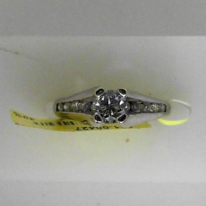 Estate Diamond Engagement Ring 
14 Karat White Estate Engagement Ring 
 Gram Weight 3.8 
1 Center Diamond 0.45ct Shape: Round; Clarity: I1; Colour: G With 10 Round Diamonds 0.25 ctw 0.7