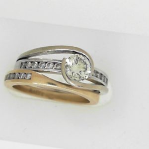 Estate Diamond Engagement Ring 
14 Karat Yellow/White Estate Engagement Ring 
Finger Size 5.5 Gram Weight 5.7 
1 Center Diamond 0.48ct Shape: Round; Clarity: I1; Colour: M With 18 Round Diamonds 0.22 ctw 0.7