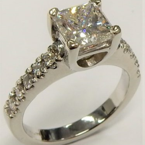 Estate Diamond Engagement Ring 
14 Karat White Estate Engagement Ring 
Finger Size 5.5 Gram Weight 5.19 
1 Center Diamond 1.59ct Shape: Square; Clarity: SI1; Colour: E; GIA 2121214342 With 10 Round Diamonds 0.20 ctw 1.79