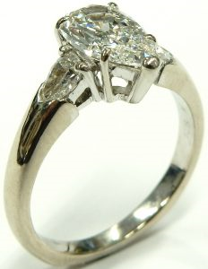 Estate Diamond Engagement Ring 
18 Karat White Estate Engagement Ring 
Finger Size 6 Gram Weight 8.1 
1 Center Diamond 1.26ct Shape: Pear; Clarity: VS1; Colour: I; GIA 8404049 With 2 Pear Diamonds 0.41 ctw 1.67
