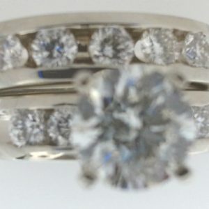 Estate Diamond Engagement Ring 
19 Karat White Estate Engagement Ring 
Finger Size 7 Gram Weight 13.6 
1 Center Diamond 1.50ct Shape: Round; Clarity: SI3; Colour: I; GIA 5192628722 With 9 Round Diamonds 1.00 ctw 2.5