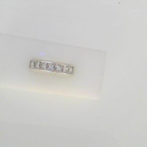 Diamond Wedding/Anniversary Ring 
18 Karat White Wedding/Anniversary Ring 
Finger Size 6 Gram Weight 6.6 
7 Center Diamonds Shape: Princess; Clarity: VS; Colour: I 1.44