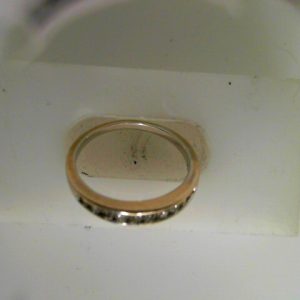 Estate Diamond Anniversary Ring 
14 Karat White Estate Anniversary Ring 
Finger Size 6.54 Gram Weight 2.12 
10 Center Diamonds Shape: Round 0.3