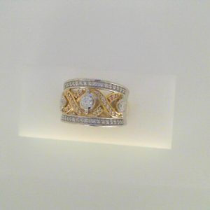 Diamond Dinner Ring - Women's 
14 Karat Yellow/White Dinner Ring Width 8.1mm 
Finger Size 6.5 Gram Weight 9.4 
 Center Diamond Shape: Round 0.7