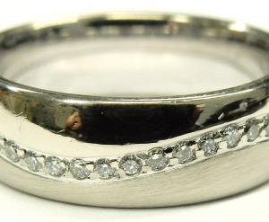 Estate Diamond Dinner Ring - Women's 
14 Karat White Estate Dinner Ring Width 5.8mm 
Finger Size 5.5 Gram Weight 6.1 
 Center Diamond Shape: Round 0.35