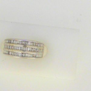 Estate Diamond Dinner Ring - Women's 
18 Karat White Estate Dinner Ring 
Finger Size 4.5 Gram Weight 4.3 
 Center Diamond Shape: Baguette; Clarity: SI2; Colour: I/J 1